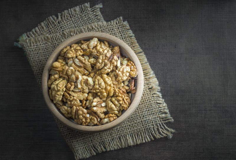 Walnuts in the wooden bowl on table