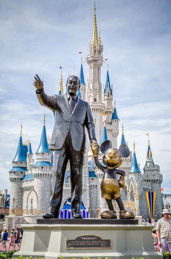 The Walt Disney and Mickey Mouse statue in front of Cinderella's castle at Disney World in Orlando Florida. The Walt Disney and Mickey Mouse statue in front of Cinderella's castle at Disney World in Orlando Florida.