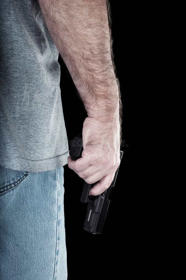 A man carries a semi automatic pistol looking for trouble. A man carries a semi automatic pistol looking for trouble.