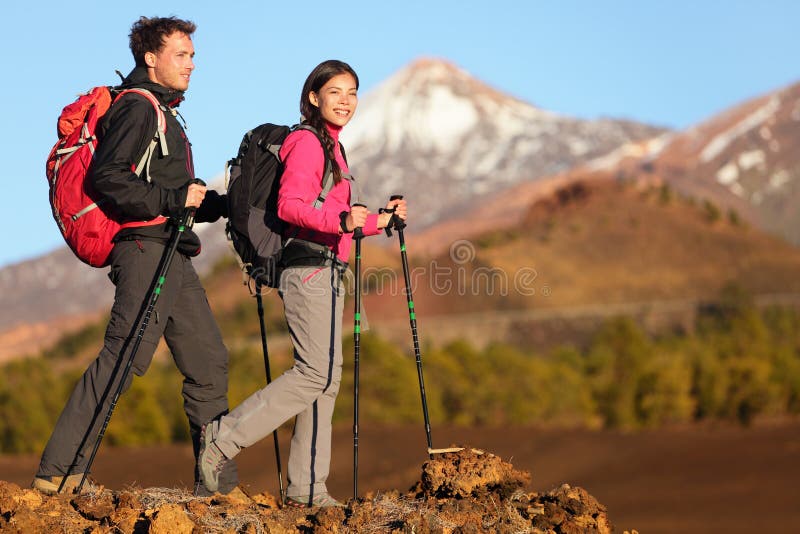 Hikers people hiking - healthy active lifestyle. Hiker people hiking in beautiful mountain nature landscape. Woman and men hikers walking during hike on volcano Teide, Tenerife, Canary Islands, Spain. Hikers people hiking - healthy active lifestyle. Hiker people hiking in beautiful mountain nature landscape. Woman and men hikers walking during hike on volcano Teide, Tenerife, Canary Islands, Spain.