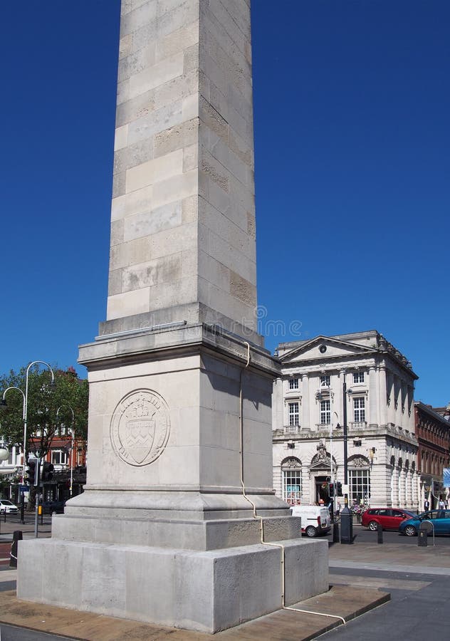 The war memorial in the town square at southport merseyside with surrounding buildings and traffic against a blue summer sky royalty free stock photo The war memorial in the town square at southport merseyside with surrounding buildings and traffic against a blue summer sky royalty free stock photo