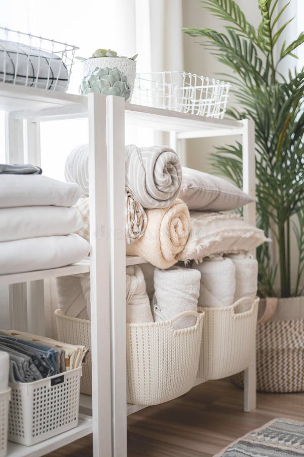 Neatly folded linen cupboard shelves storage at eco friendly straw