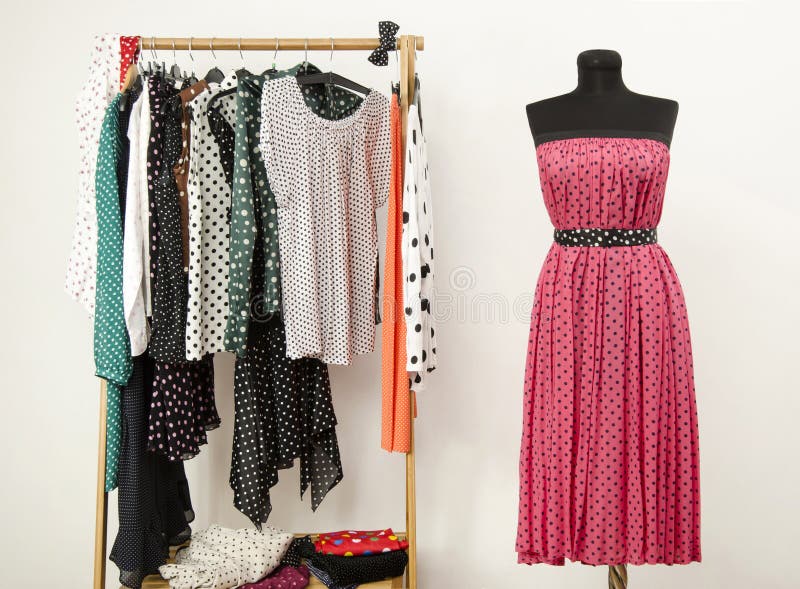 Wardrobe with Polka Dots Clothes Arranged on Hangers and a Pink Dress ...