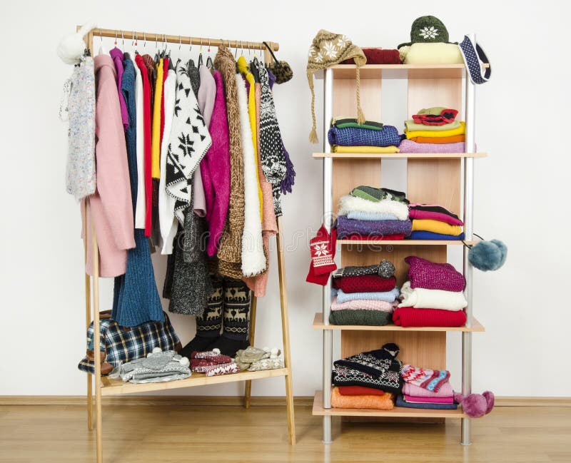 Wardrobe With Complementary Colors Orange And Blue Clothes Arranged On  Hangers. Dressing Closet With Clothes, Shoes And Accessories And A Dress On  A Mannequin. Stock Photo, Picture and Royalty Free Image. Image