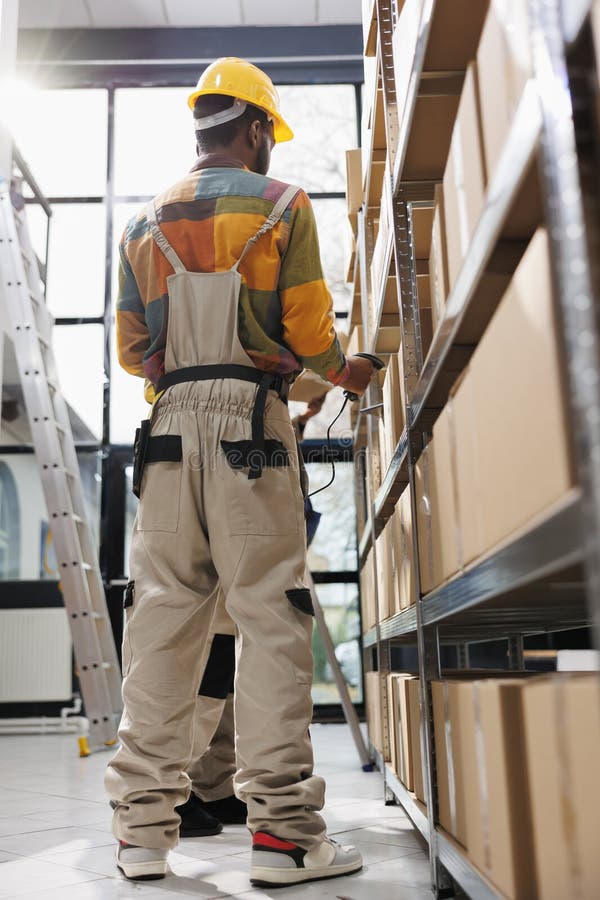Warehouse employees managing products storing using barcode scanner stock images