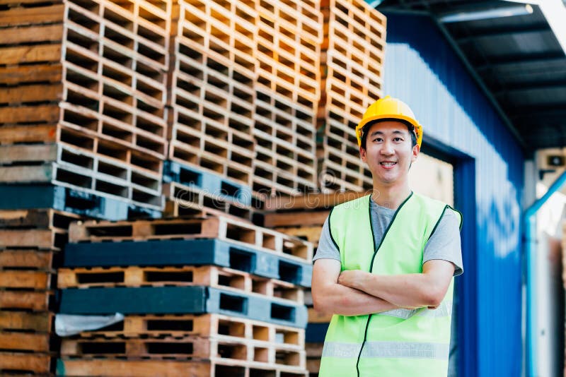 Warehouse and logistics industrial worker smiling with arms crossed royalty free stock photos Warehouse and logistics industrial worker smiling with arms crossed royalty free stock photos