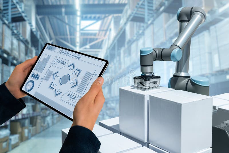 Warehouse manager with digital tablet controls robot arm. Controls automation stock images, royalty-free photos and pictures