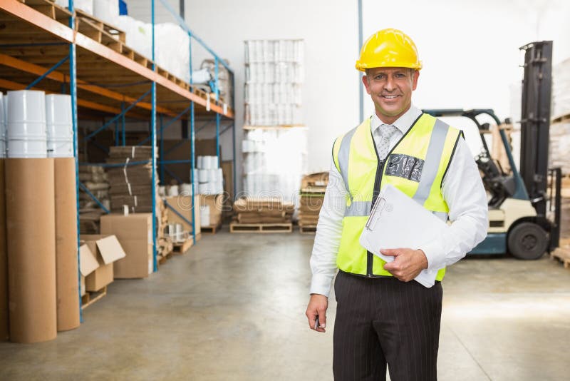 Warehouse Manager Wearing Hard Hat Holding Clipboard Stock Image