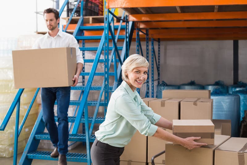Warehouse managers loading a trolley stock photography