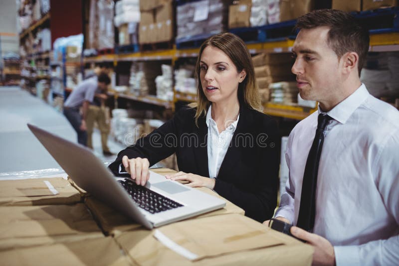 Warehouse Managers Using Laptop Stock Photo Image of colleagues