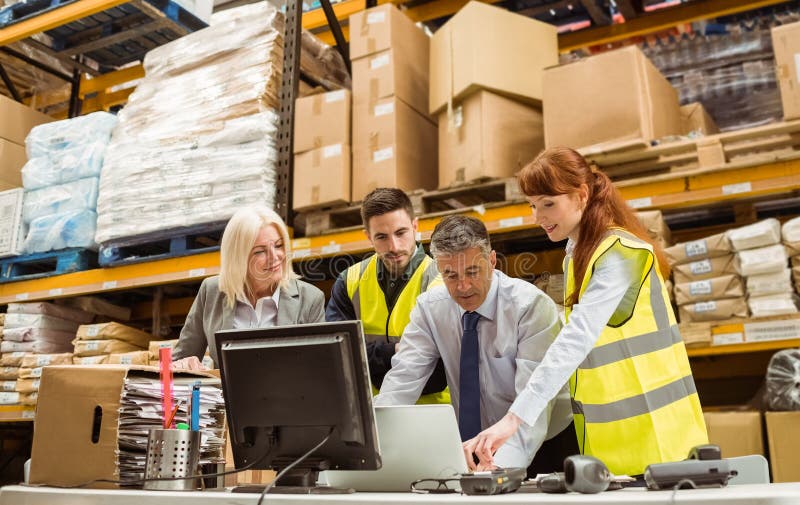 Warehouse managers and worker working on laptop royalty free stock photo Warehouse managers and worker working on laptop royalty free stock photo