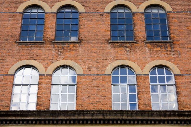Arched warehouse windows stock image. Image of industry 45981975