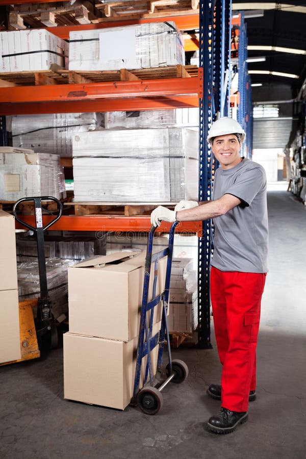 Warehouse Worker with Handtruck Loading Cardboard Stock Image Image