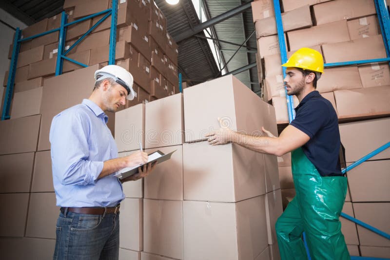 Warehouse Worker Loading Up a Pallet with Manager Stock Photo Image