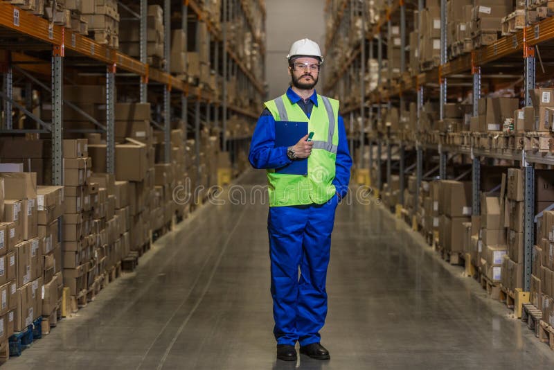 Warehouse Worker Standing between Rows with Boxes Stock Image Image