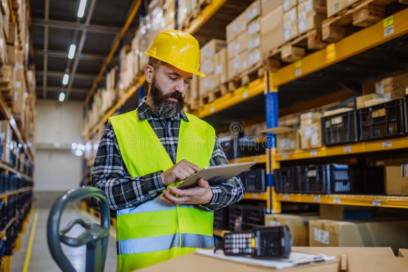 Warehouse Worker Stocking Goods in a Warehouse. Stock Image Image of protective, manufacturing