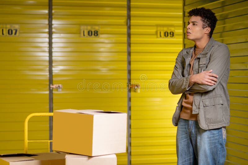 Open the locker. Warehouse worker trying to open the locker and looking puzzled