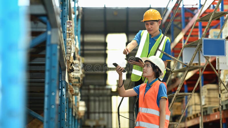 Warehouse worker are using barcode scanner checking stock on shelves in a retail warehouse royalty free stock photos