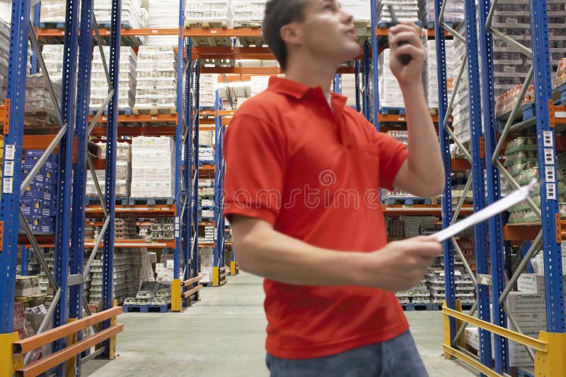Warehouse Worker Using Walkie Talkie stock images