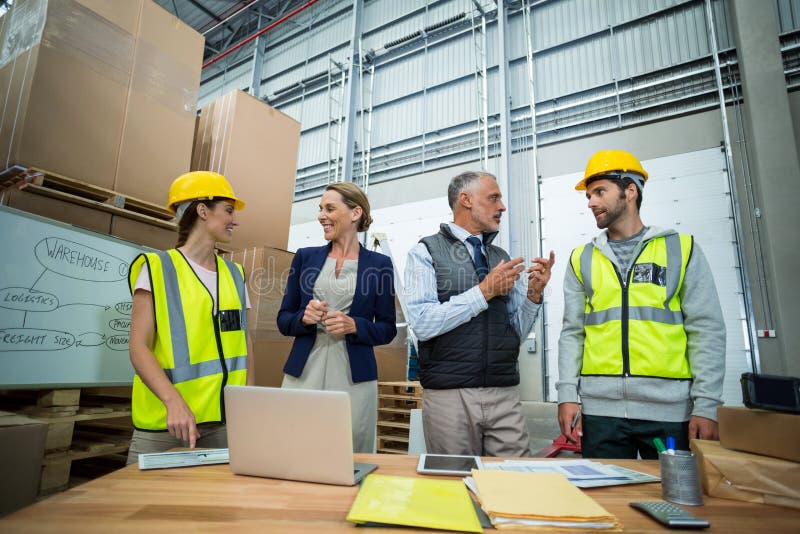 Warehouse Workers and Managers Interacting with Each Other Stock Image
