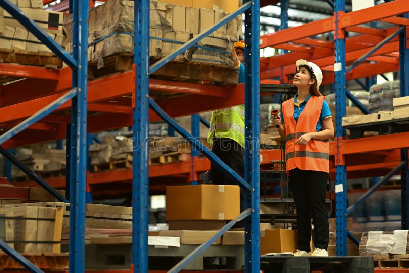 Warehouse Workers Wearing Safety Hardhat Working on Retail Warehouse