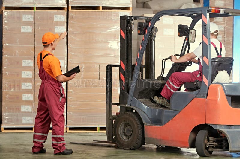 Warehousing and storage. warehouse workers works with forklift loader