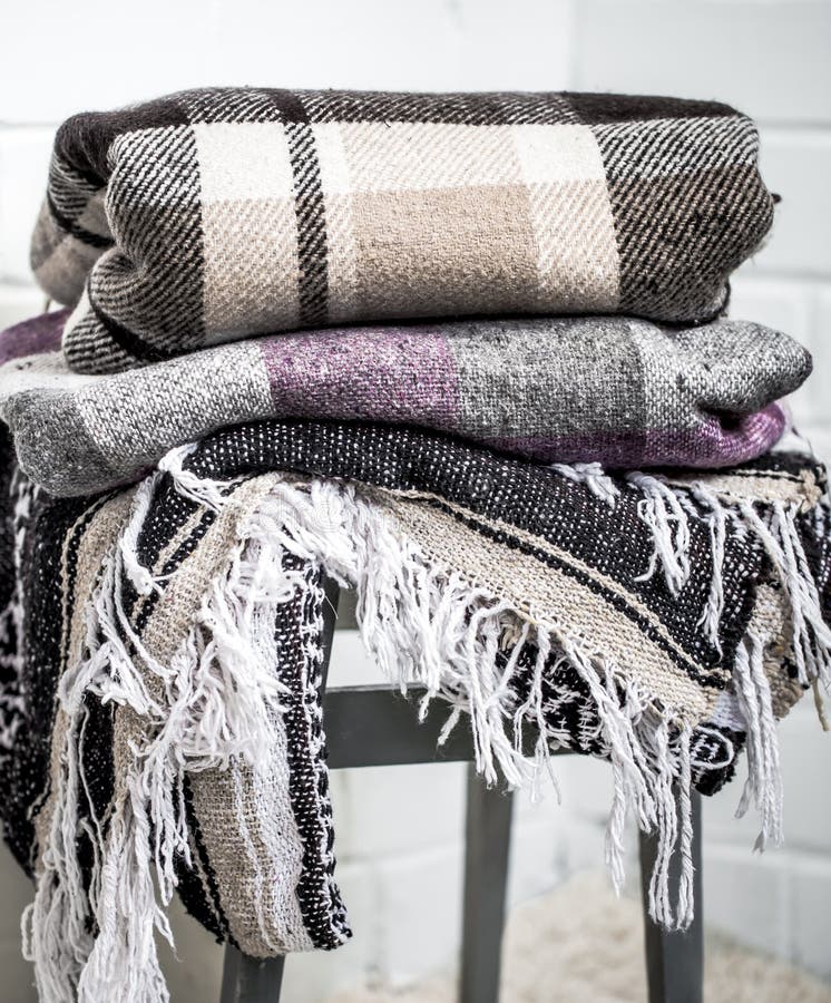 Warm blankets on a chair stock image. Image of interior 97093897