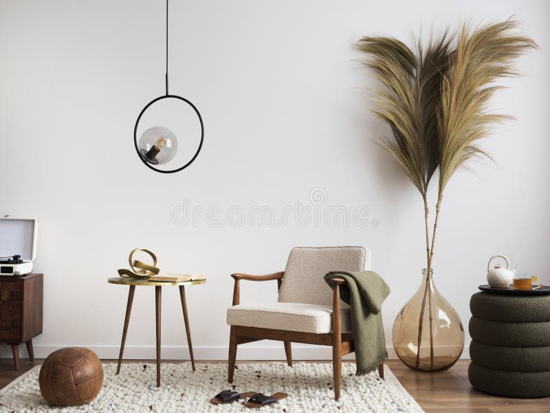 Warm bedroom interior with mock up poster frame, cozy bed, beige bedding,  stylish lamp, round box, black rack, wall with stucco, rattan armchair and  personal accessories. Home decor. Template. Stock Photo