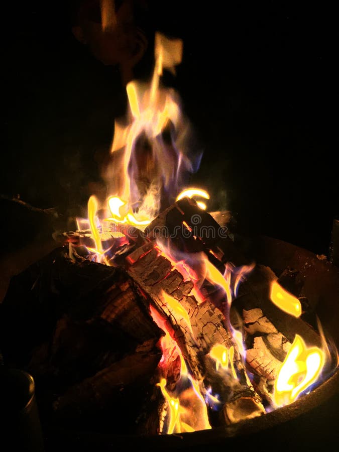 Warm outdoor fire burning orange at night with glowing logs royalty free stock images Warm outdoor fire burning orange at night with glowing logs royalty free stock images