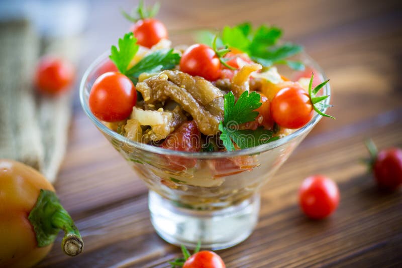 A warm salad of baked eggplant and peppers with cherry tomatoes