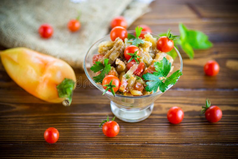 A warm salad of baked eggplant and peppers with cherry tomatoes