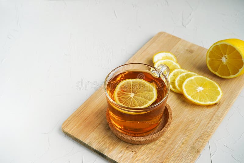 Warm Tea with Lemon on a Wooden Board. a Warming Drink for Colds Stock