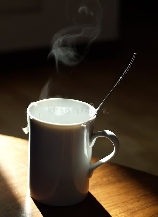 Warm tea mug over timber table. Warm steam stock images, royalty-free photos and pictures