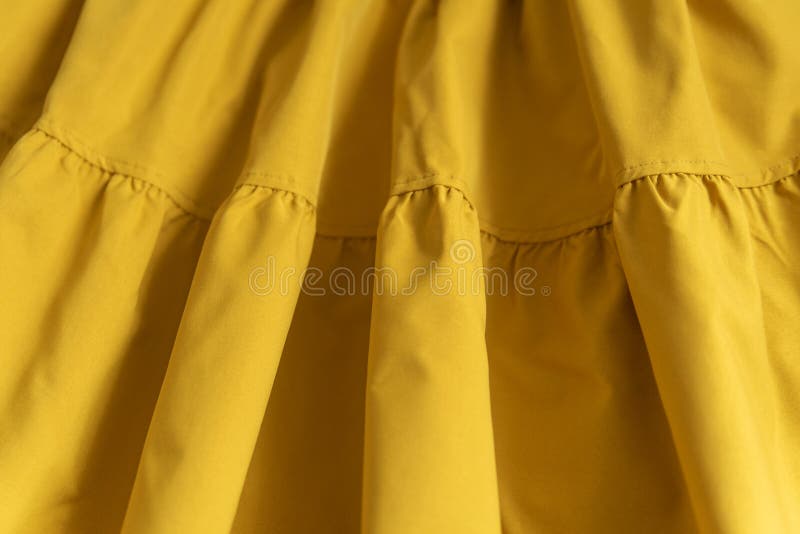 Warm Yellow or Mustard Color Fabric Folded by Wave, Texture Background. Texture of Cotton