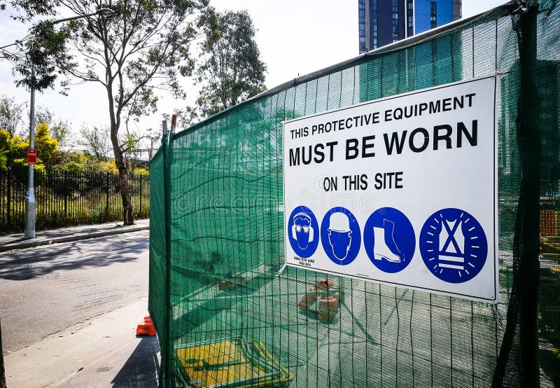 Warning sign construction site for must be worn this protective equipment on this site. stock photo Warning sign construction site for must be worn this protective equipment on this site. stock photo