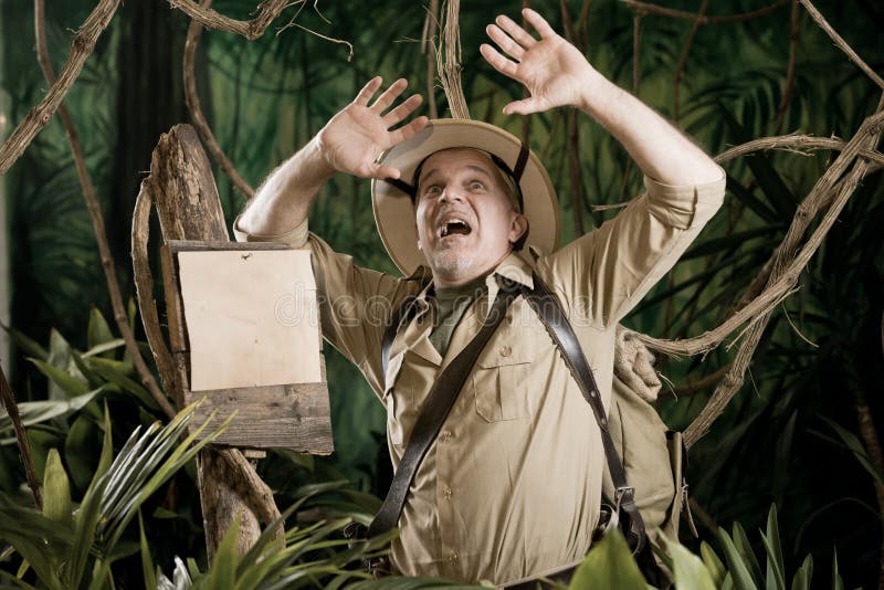 Terrified explorer in the jungle with arms raised looking up and warning sign. Adventurer adventure stock images, royalty-free photos and pictures