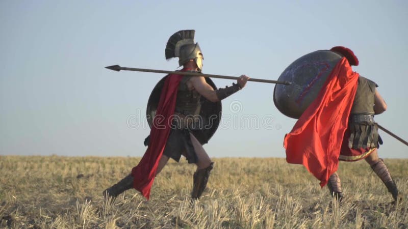 The warrior beautifully beats his shoulder with a spear on his opponent