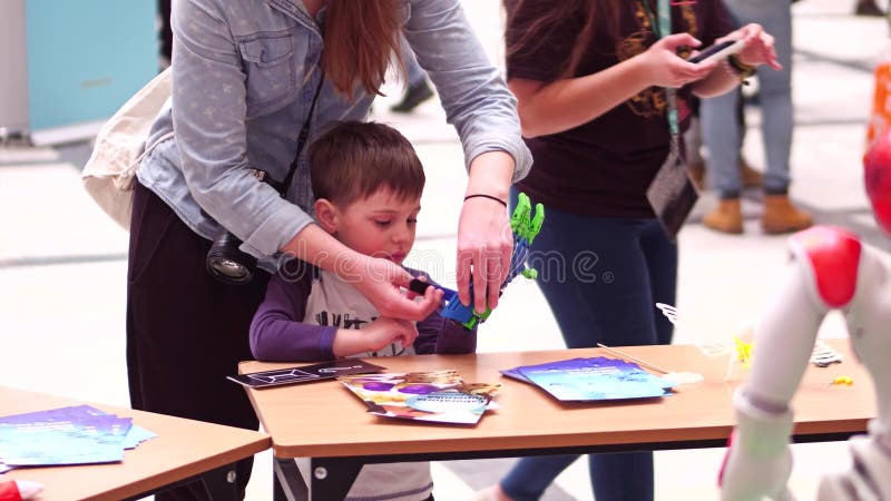 WARSAW, POLAND - MARCH, 4, 2017. Little boy wearing toy robot hand royalty free stock photos WARSAW, POLAND - MARCH, 4, 2017. Little boy wearing toy robot hand royalty free stock photos
