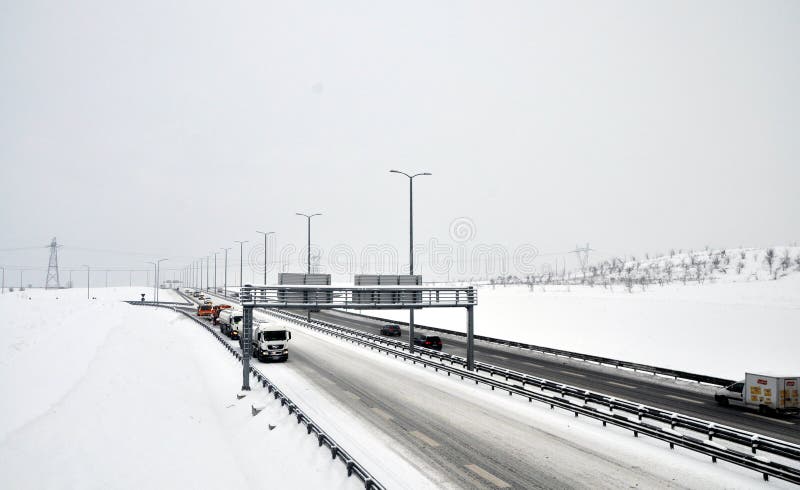 Cars and trucks driving on dangerous, snow packed roads during a snowstorm. Cars and trucks driving on dangerous, snow packed roads during a snowstorm.