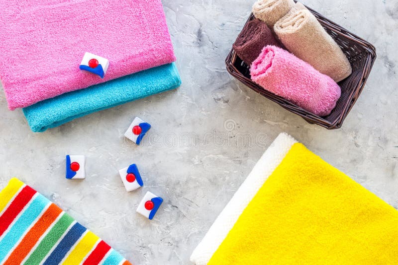 Wash Clothes. Clean Towel and Detergent on Grey Stone Background Top