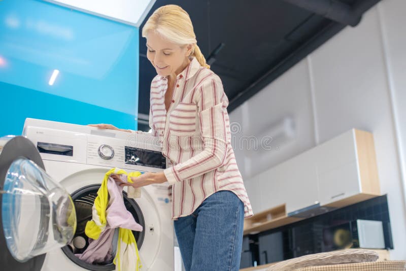 Blonde Housewife Taking Clothes from Washing Machine Stock Photo ...