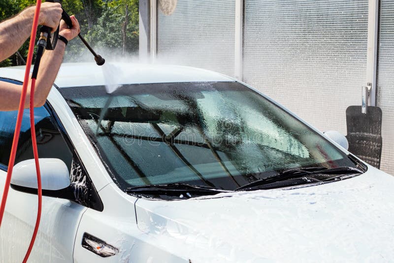 Water Jet From A Hose On The Windshield At A Selfservice Car Wash