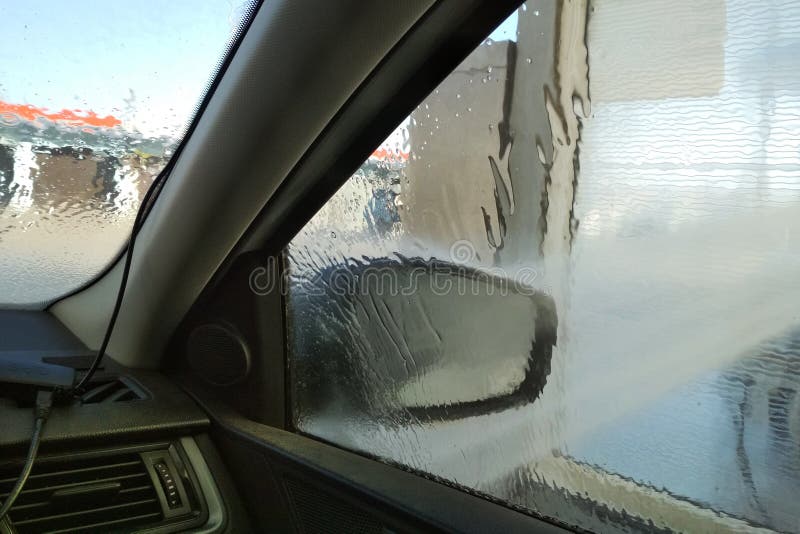 Washing Car in a Selfservice Car Wash Station. Shooting from Inside