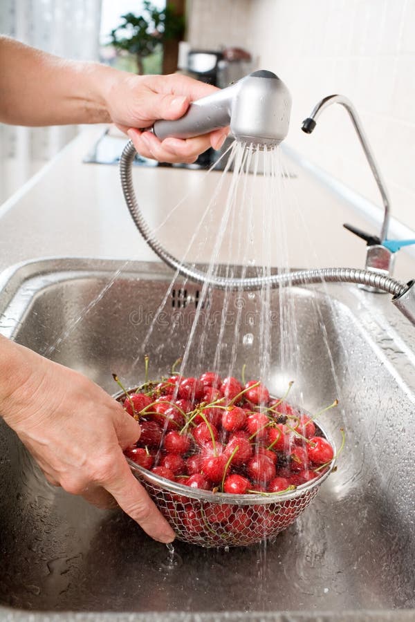 Washing cherry in sink