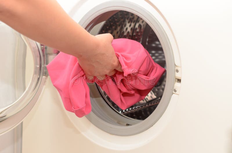 Washing Dirty Clothes in an Automatic Washing Machine. Stock Photo