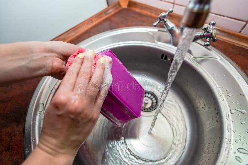 Washing the Dishes in the Kitchen Sink. Cleaning Work Stock Image