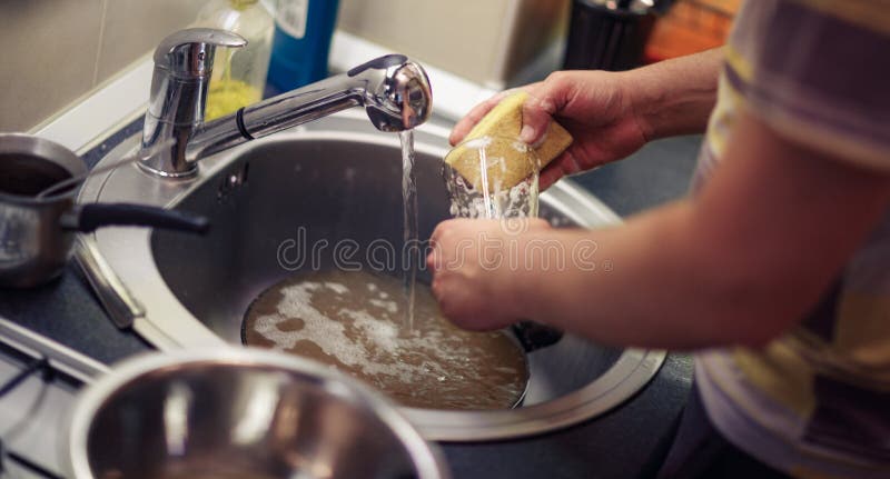 Washing dishes. male hands in foam washes the frying pan with a royalty free stock photos Washing dishes. male hands in foam washes the frying pan with a royalty free stock photos