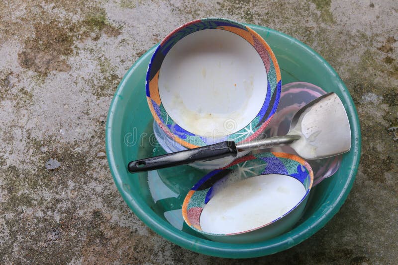 Washing Dishes In Sink Plastic Green On The Cement Floor Stock Photo
