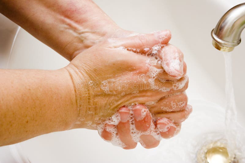 Žena umývanie rúk pod tečúcou vodou biele umývadlo chrome náustok.