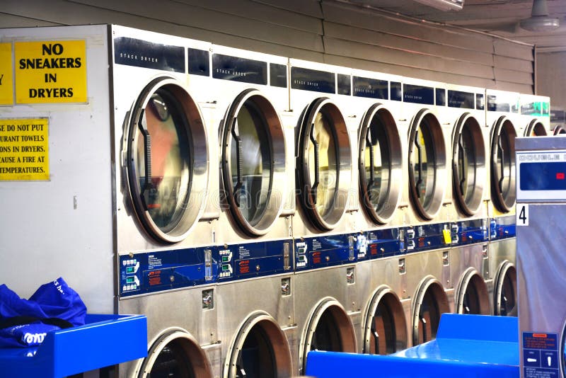 Washing machines inside laundry shop or launderette royalty free stock photos